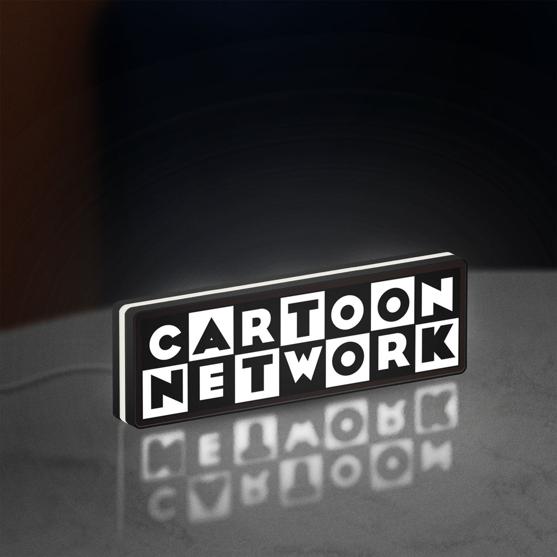 Cartoon Network LED lightbox hanging on a wall with white glow