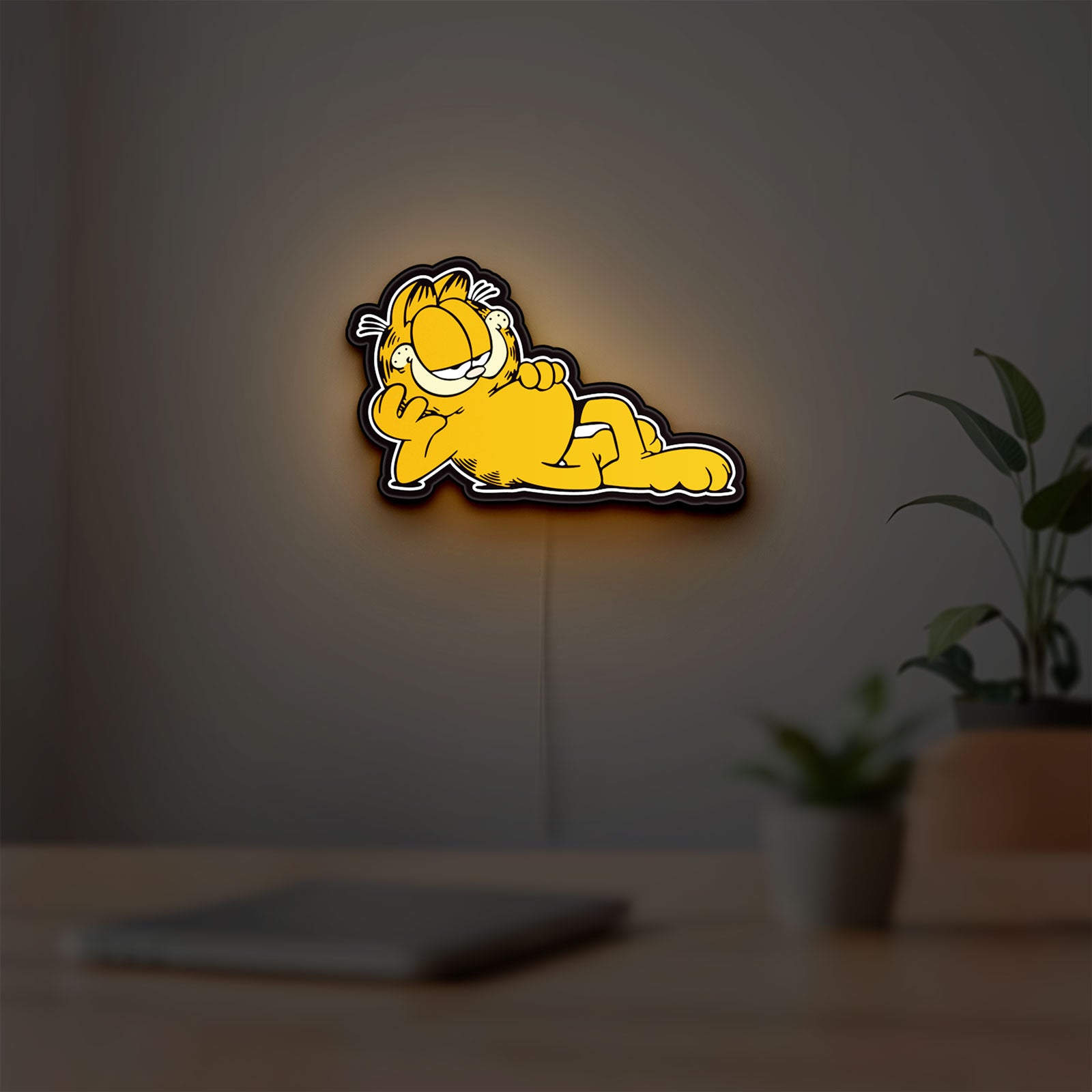 Garfield LED lightbox hanging on a room wall with soft orange light