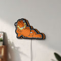Unlit Garfield LED lightbox mounted on a wall in daylight