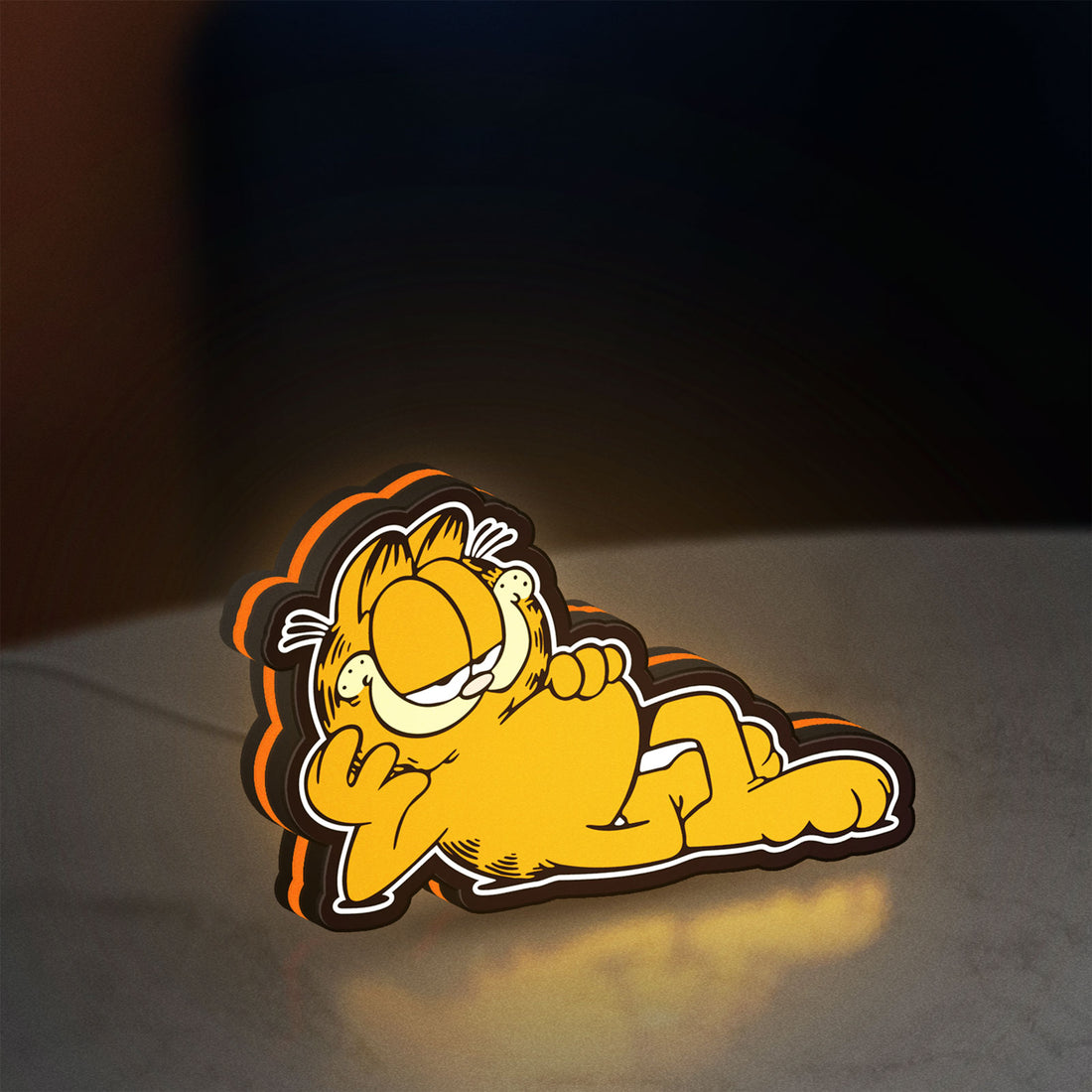 Garfield LED lightbox hanging on a wall with orange glow