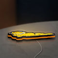 Garfield LED lightbox lying flat on a desk with orange glow