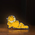 Front view of Garfield LED lightbox sign glowing on a wooden desk