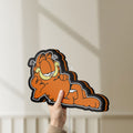 Unlit Garfield LED lightbox held by hand to show size and details