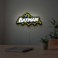 Batman LED lightbox hanging on a room wall with soft yellow light