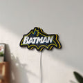 Unlit Batman LED lightbox mounted on a wall in daylight