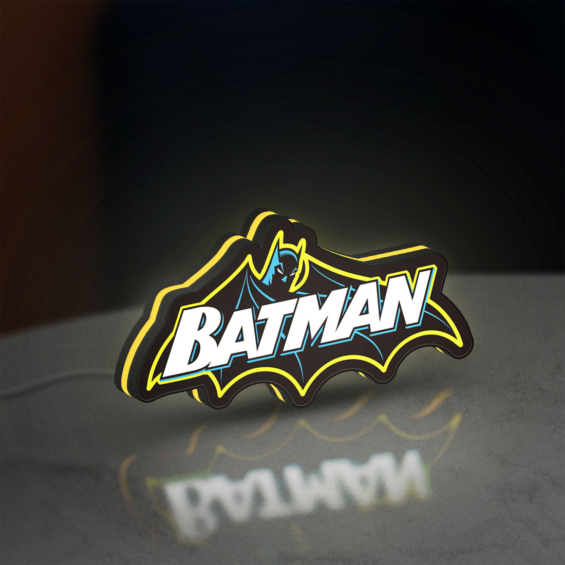 Batman LED lightbox hanging on a wall with yellow glow