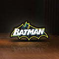 Front view of Batman LED lightbox sign glowing on a wooden desk