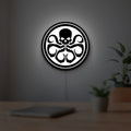 Hydra Agents of Shield LED lightbox hanging on a room wall with soft white light