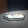Bluey Inspired LED lightbox lying flat on a desk with white glow