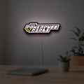 The Powerpuff Girls LED lightbox hanging on a room wall with soft pink light