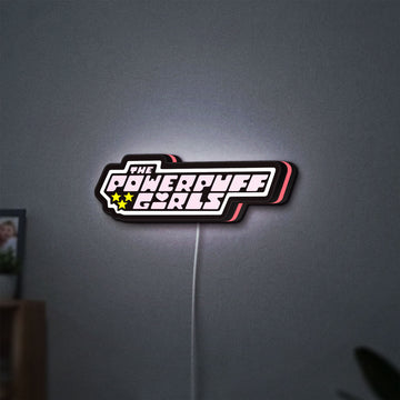 The Powerpuff Girls LED lightbox hanging on a wall with pink glow