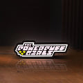 Front view of The Powerpuff Girls LED lightbox sign glowing on a wooden desk
