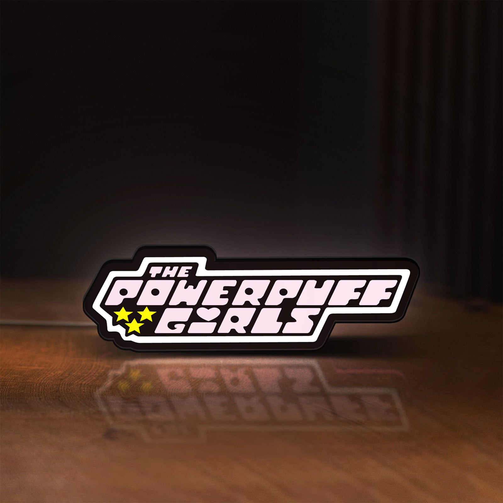 Front view of The Powerpuff Girls LED lightbox sign glowing on a wooden desk