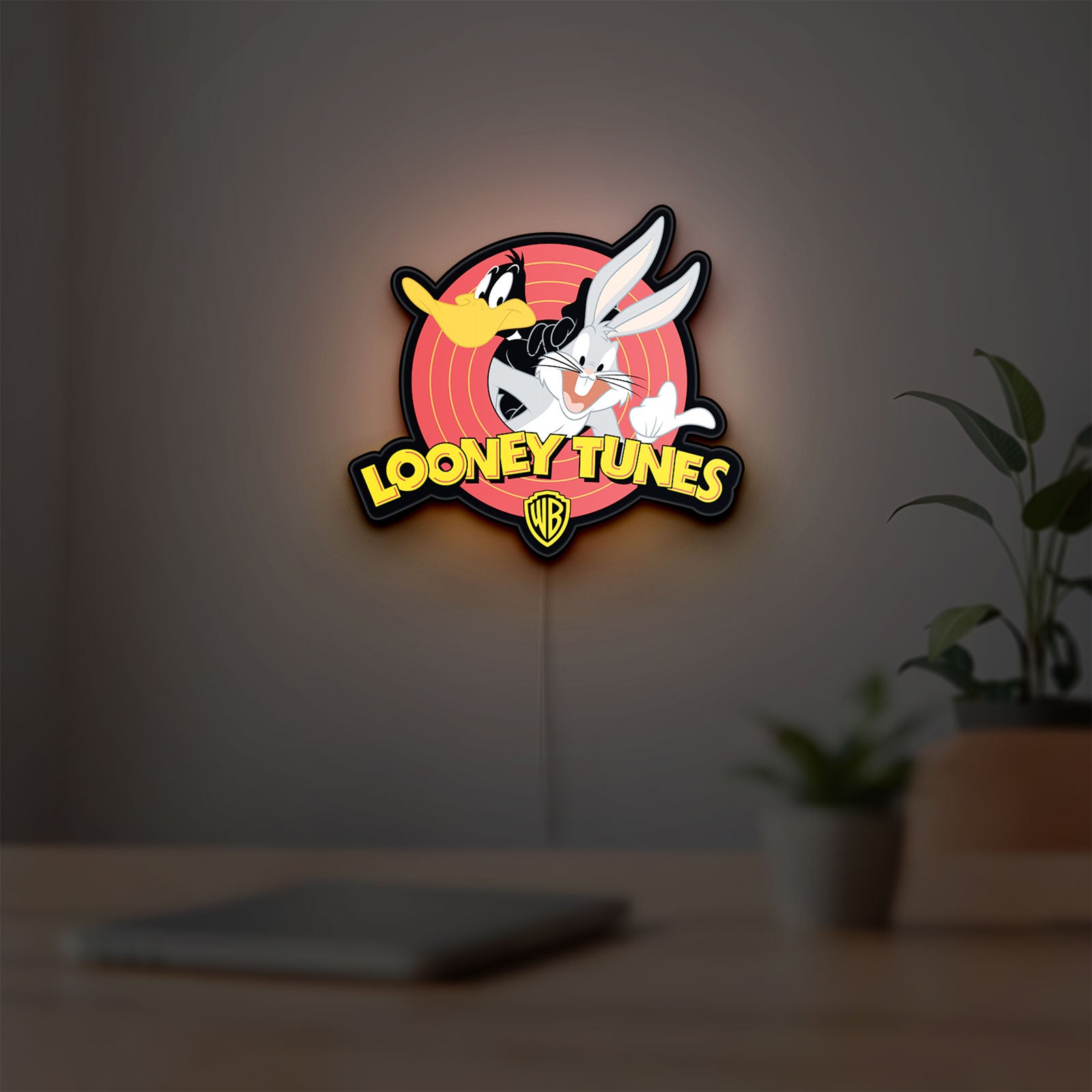 Looney Tunes LED lightbox hanging on a room wall with soft yellow light