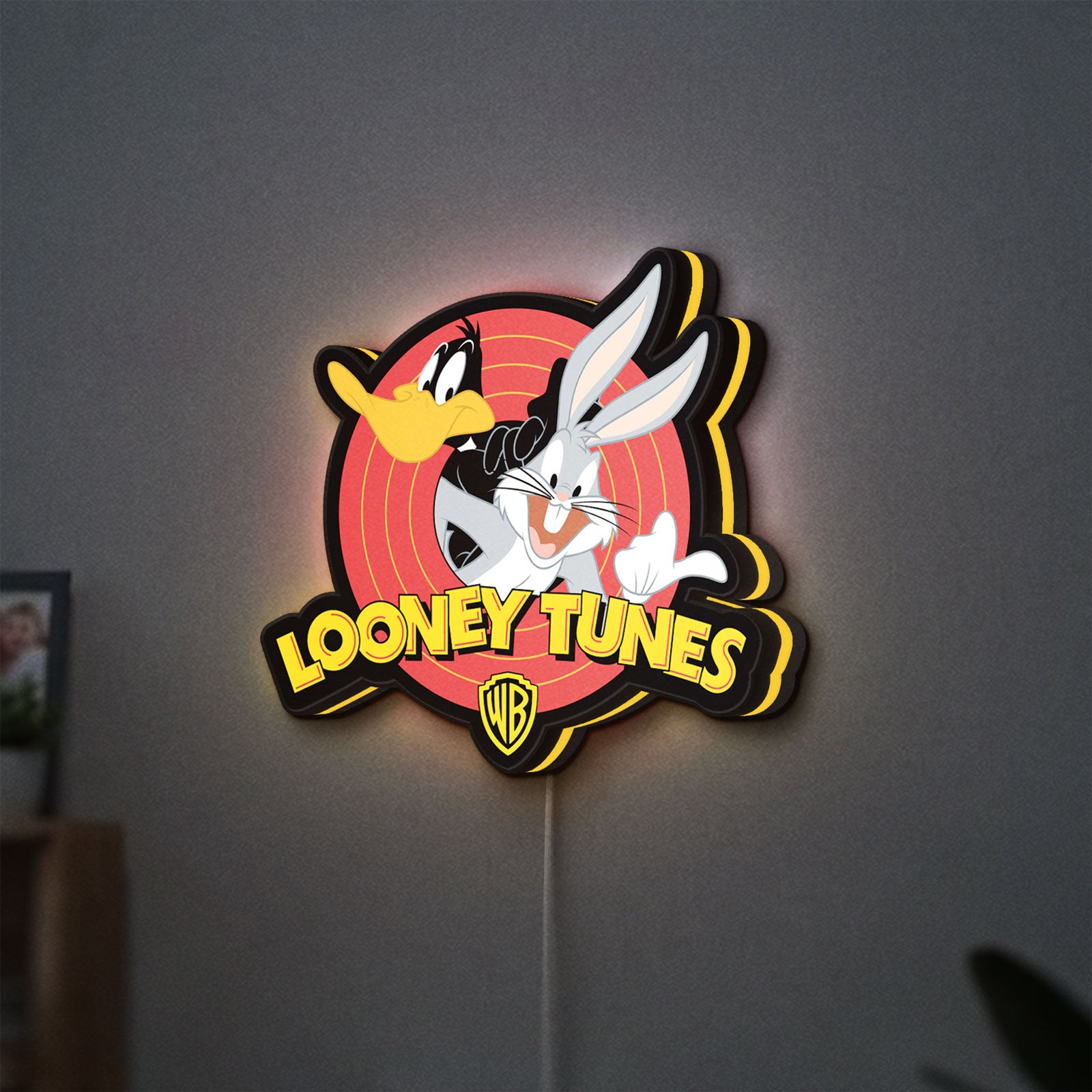 Looney Tunes LED lightbox hanging on a wall with yellow glow