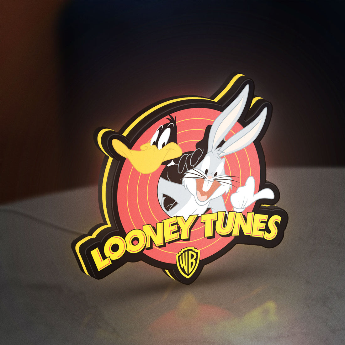 Looney Tunes LED lightbox hanging on a wall with yellow glow