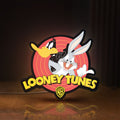 Front view of Looney Tunes LED lightbox sign glowing on a wooden desk