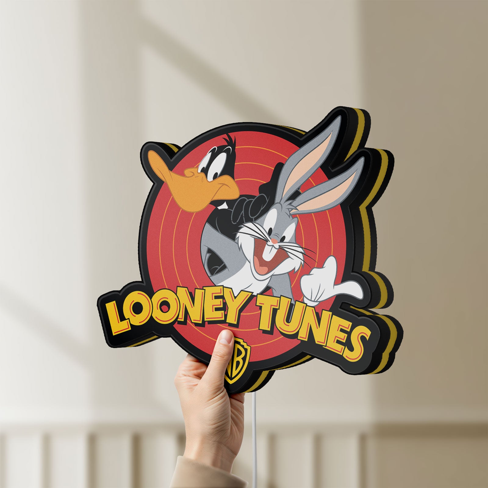 Unlit Looney Tunes LED lightbox held by hand to show size and details