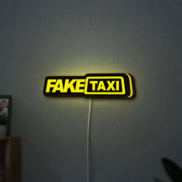 Fake Taxi LED lightbox hanging on a wall with yellow glow