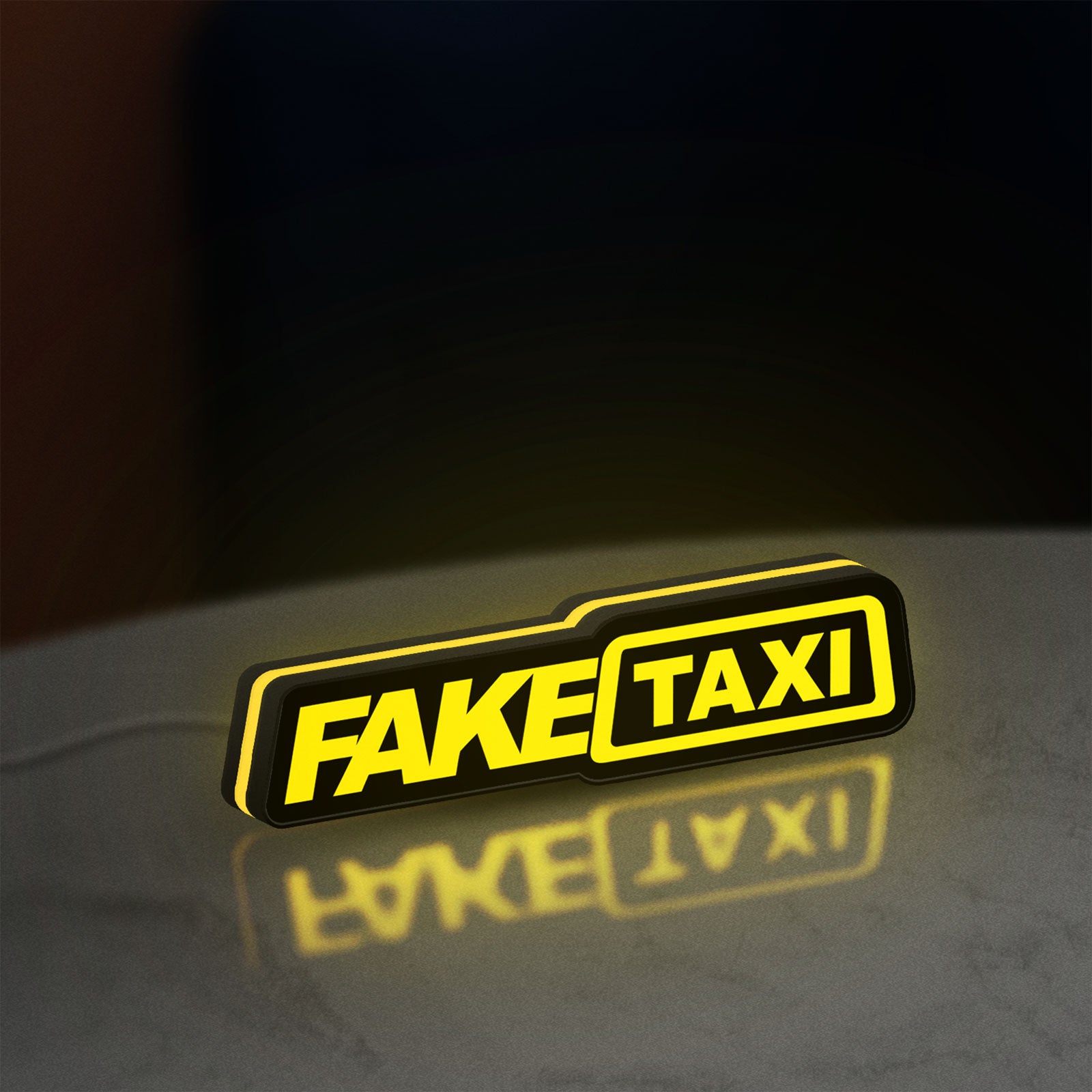 Fake Taxi LED lightbox standing on a desk from an angled side view with yellow glow
