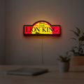Lion King LED lightbox hanging on a room wall with soft yellow light