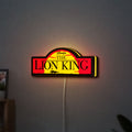 Lion King LED lightbox hanging on a wall with yellow glow