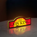 Lion King LED lightbox standing on a desk from an angled side view with yellow glow