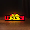 Front view of Lion King LED lightbox sign glowing on a wooden desk