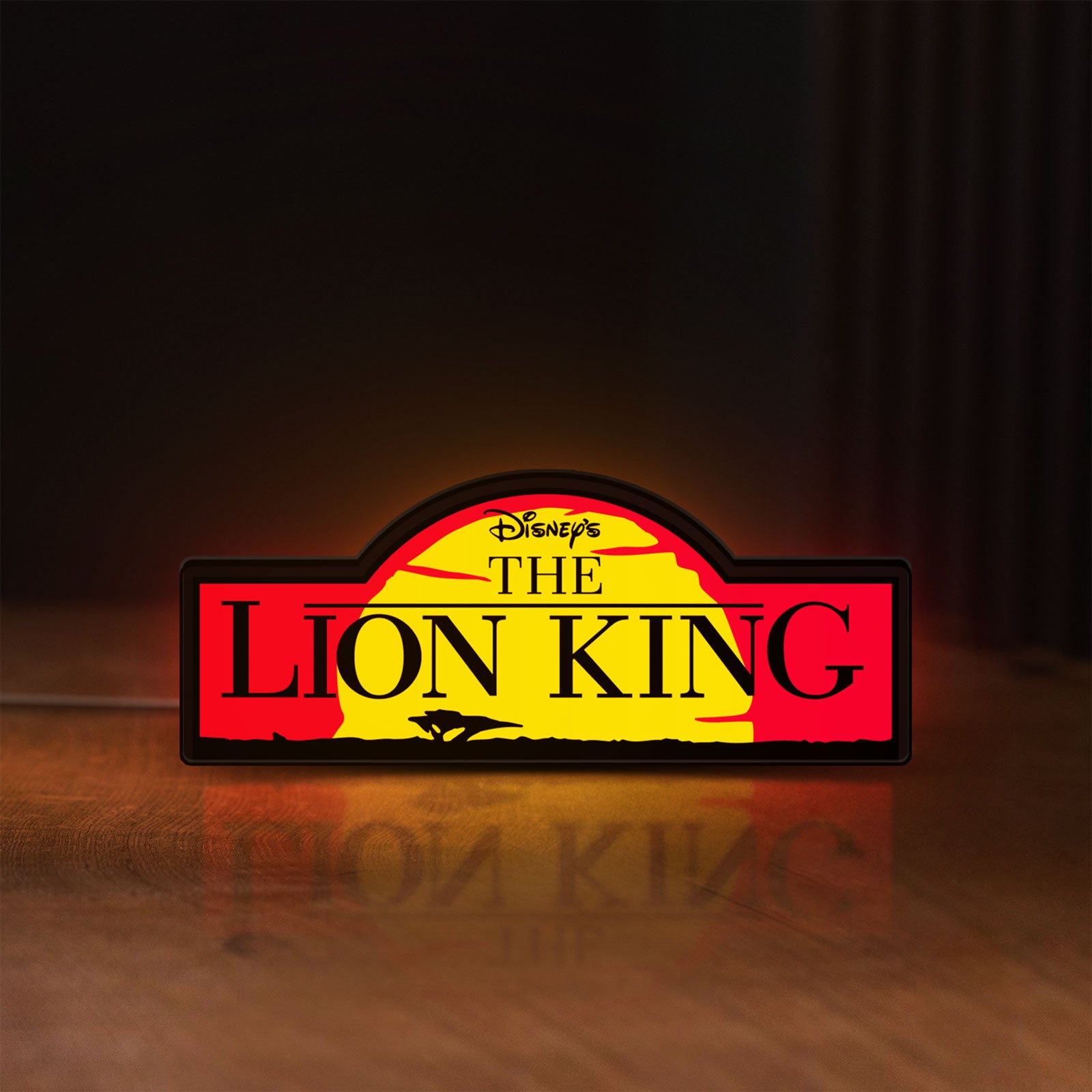 Front view of Lion King LED lightbox sign glowing on a wooden desk