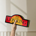 Unlit Lion King LED lightbox held by hand to show size and details