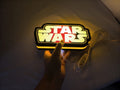 Illuminated handheld size reference of Star Wars 3D LED Sign in 20cm, great for home theater and media room decor