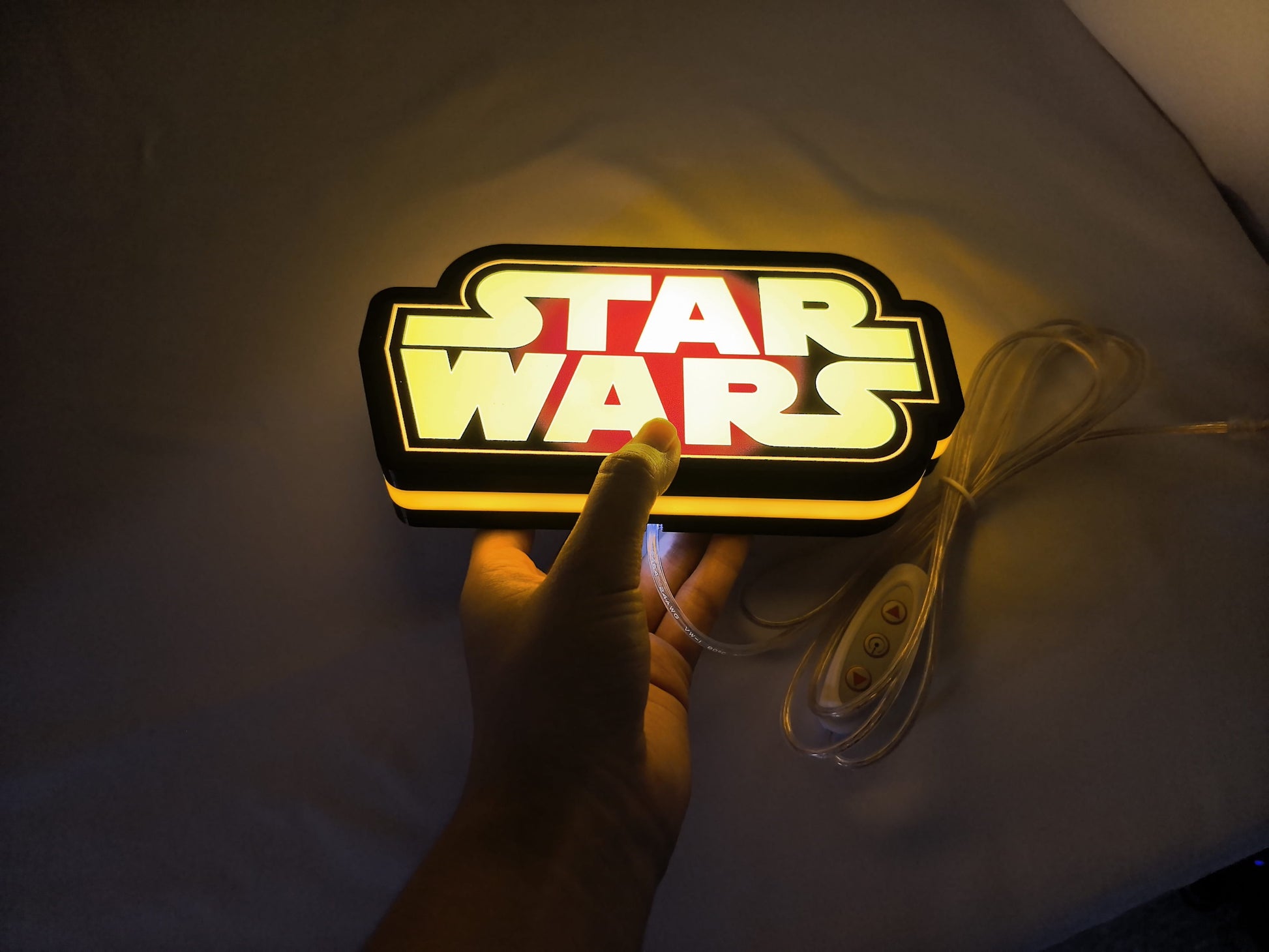 Illuminated handheld size reference of Star Wars 3D LED Sign in 20cm, great for home theater and media room decor
