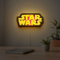 Star Wars LED lightbox hanging on a room wall with soft yellow light