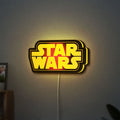 Star Wars LED lightbox hanging on a wall with yellow glow