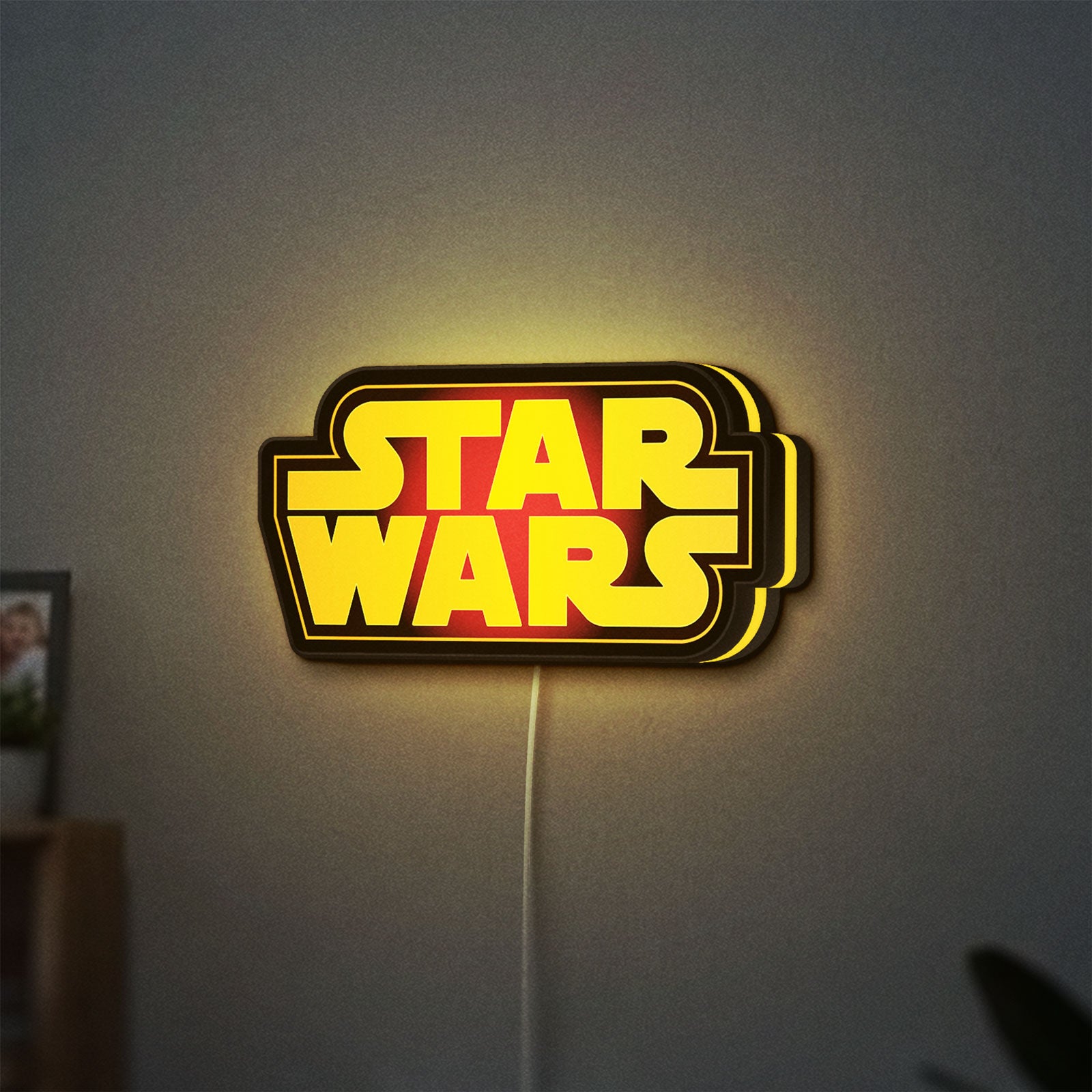 Star Wars LED lightbox hanging on a wall with yellow glow