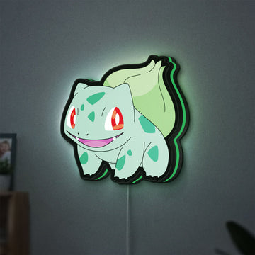 Bulbasaur LED lightbox hanging on a wall with green glow