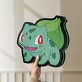 Unlit Bulbasaur LED lightbox held by hand to show size and details