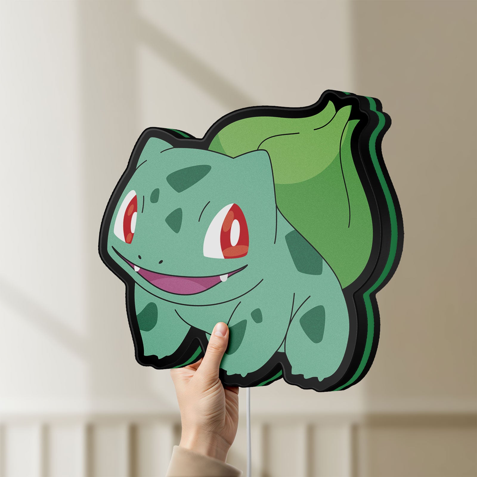 Unlit Bulbasaur LED lightbox held by hand to show size and details