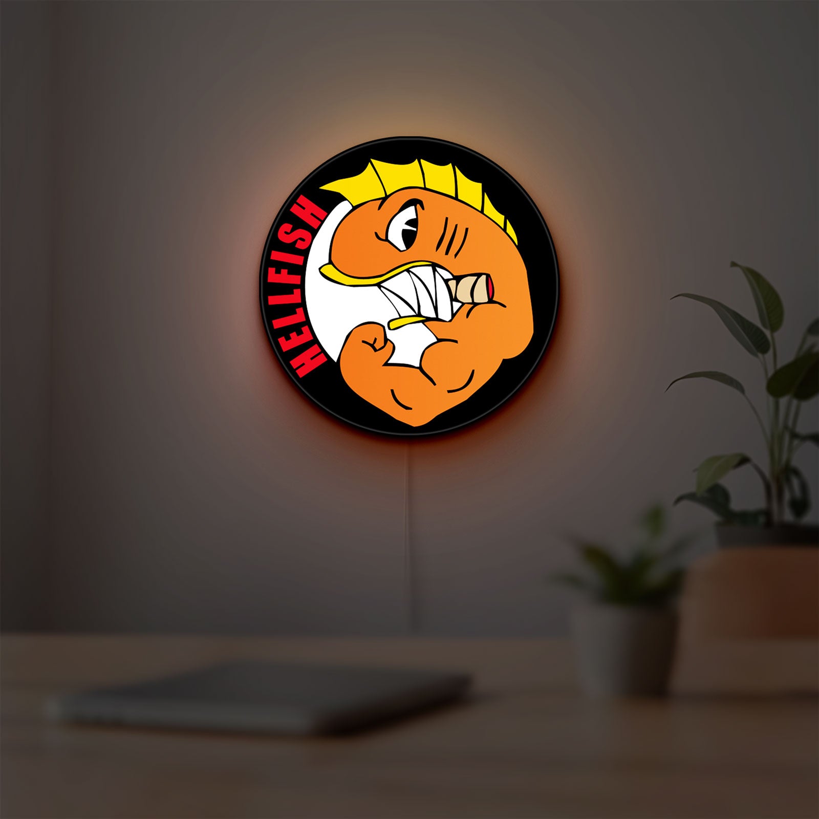 Hellfish LED lightbox hanging on a room wall with soft orange light