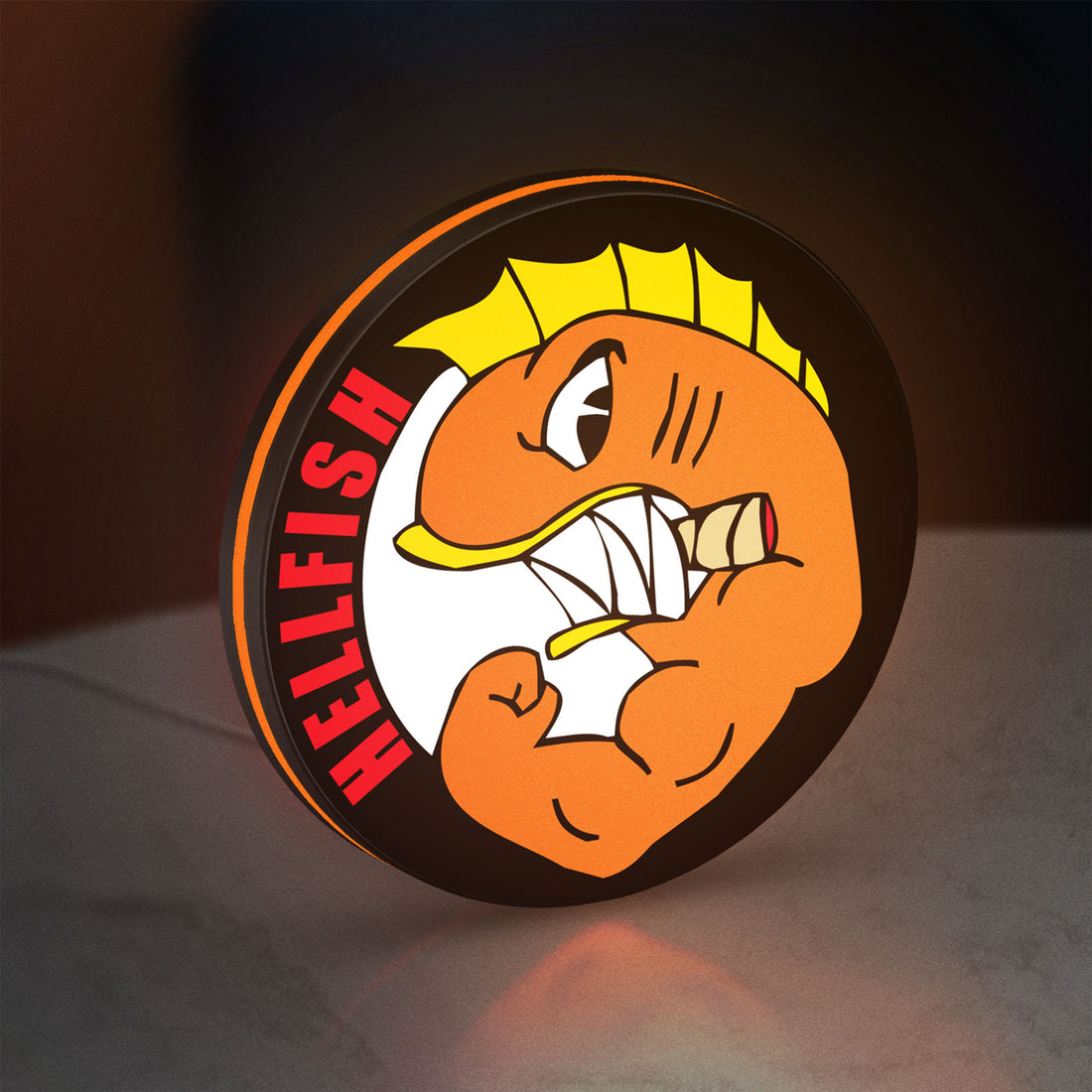 Hellfish LED lightbox hanging on a wall with orange glow