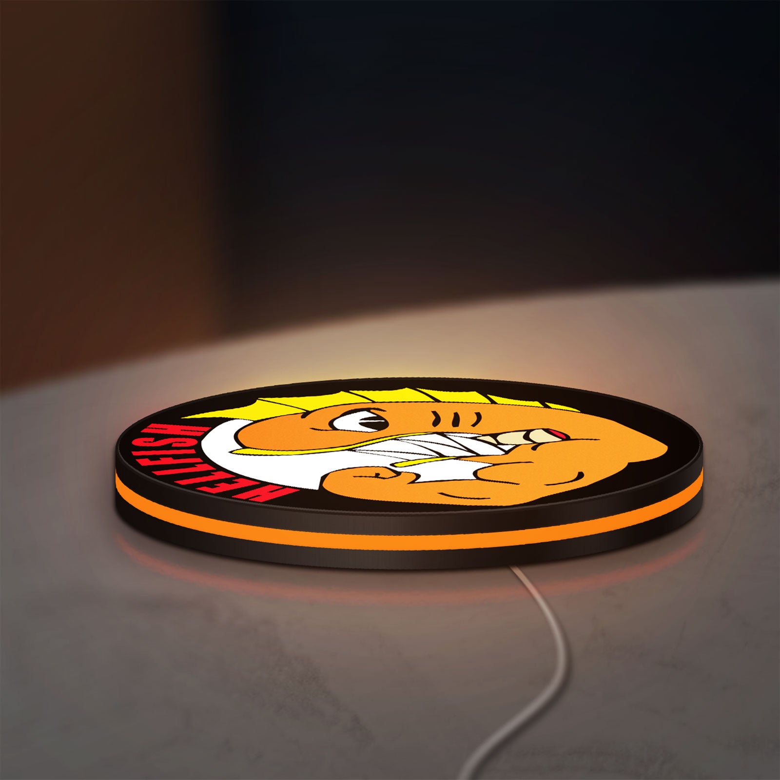Hellfish LED lightbox lying flat on a desk with orange glow