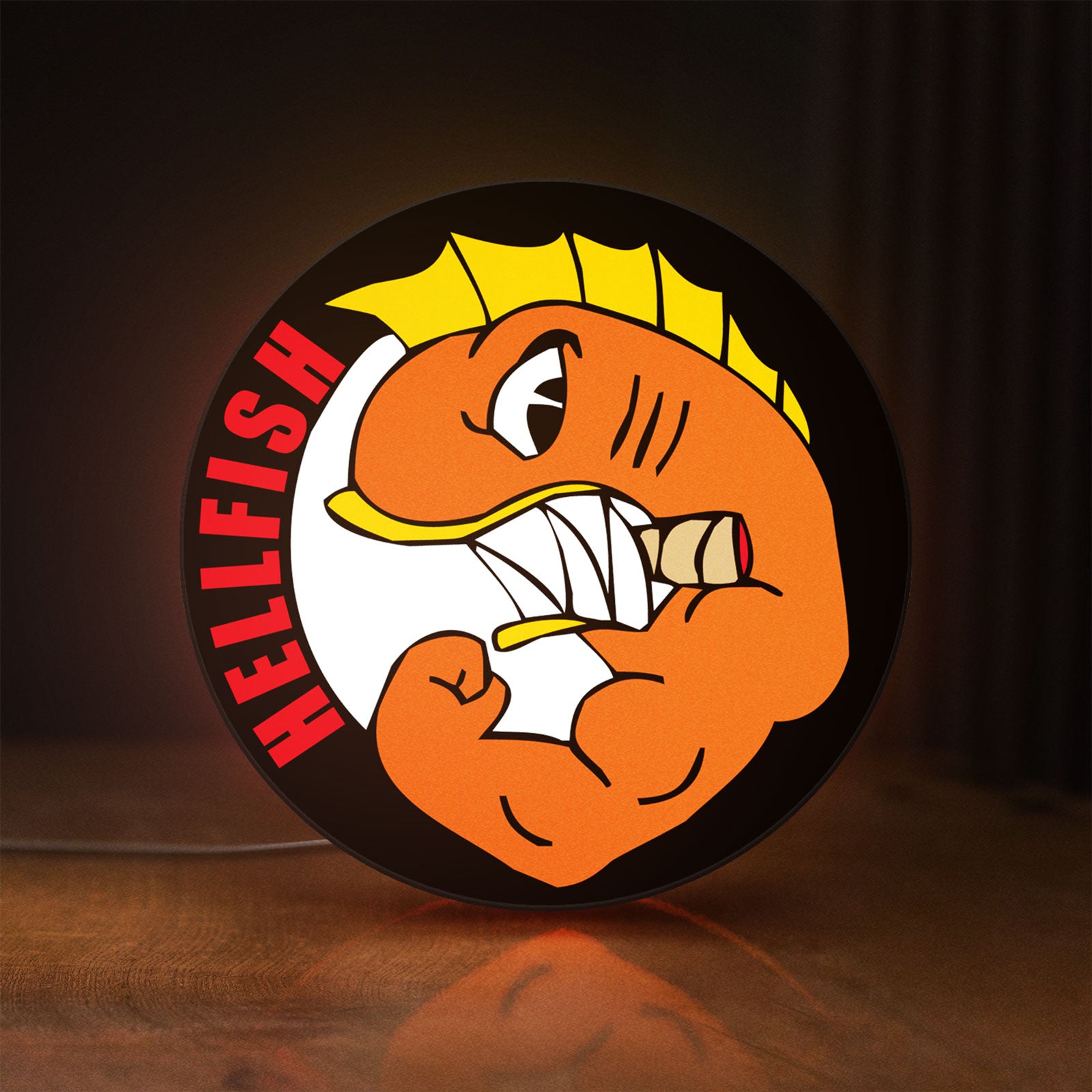Front view of Hellfish LED lightbox sign glowing on a wooden desk