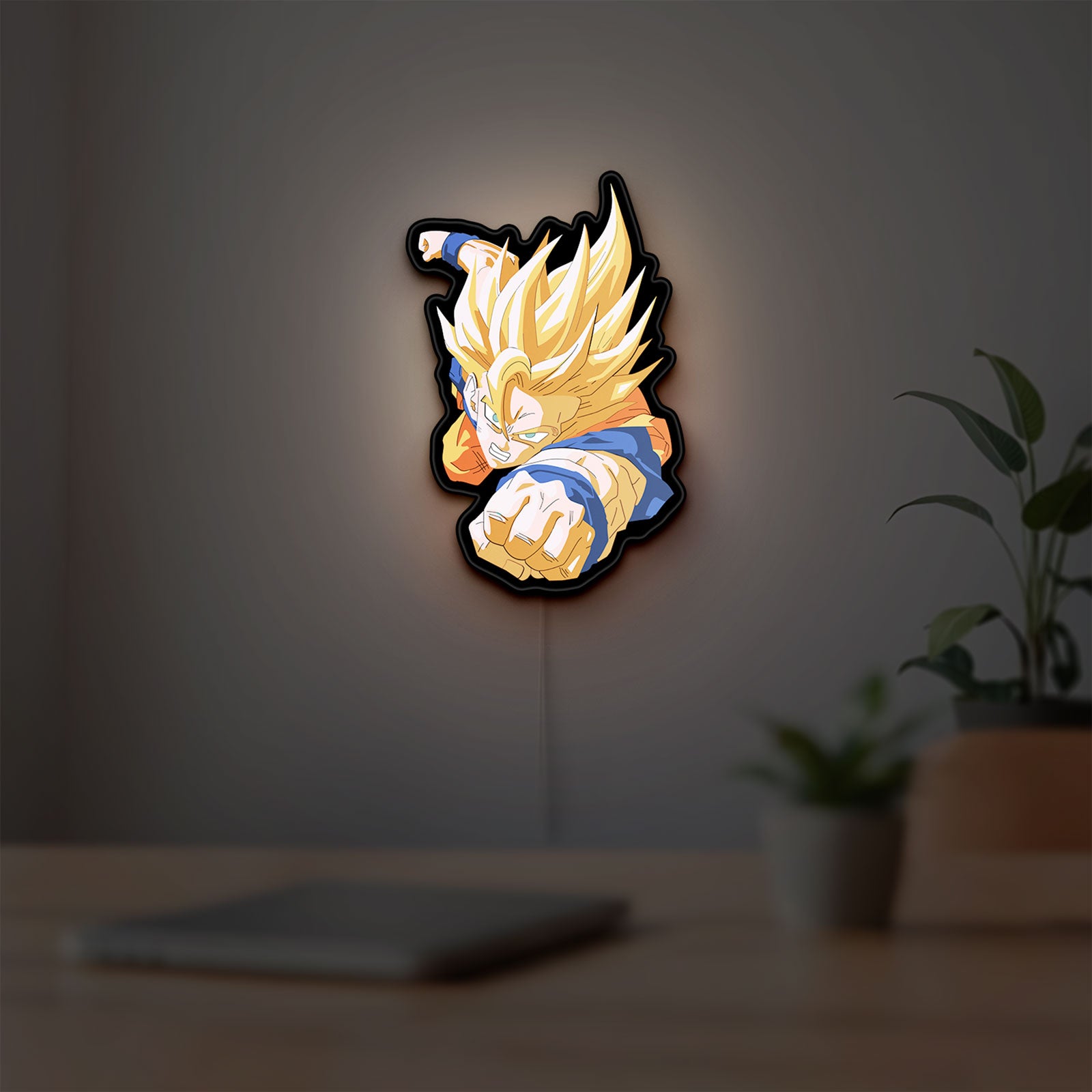 Goku LED lightbox hanging on a room wall with soft yellow light