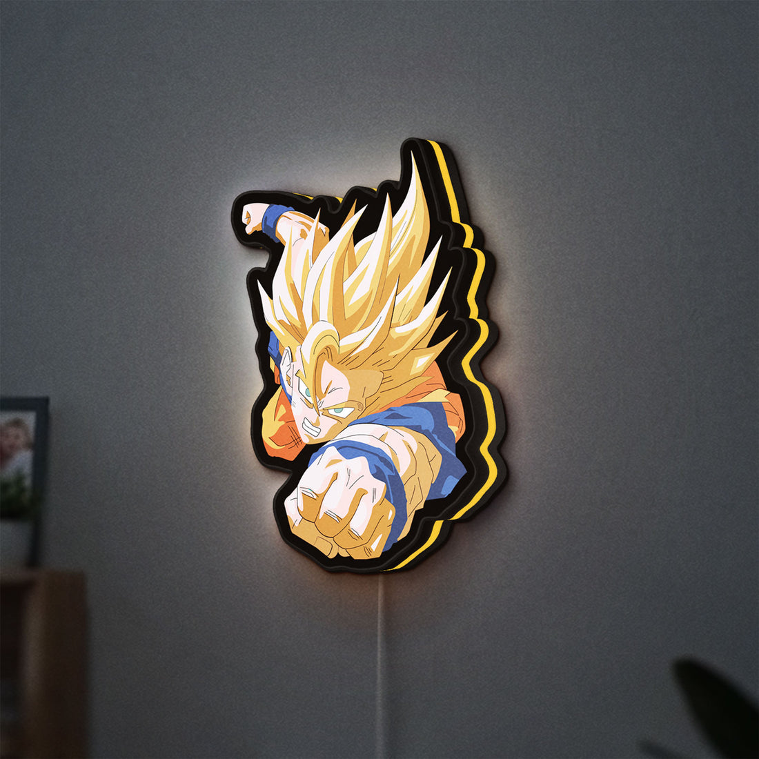 Goku LED lightbox hanging on a wall with yellow glow