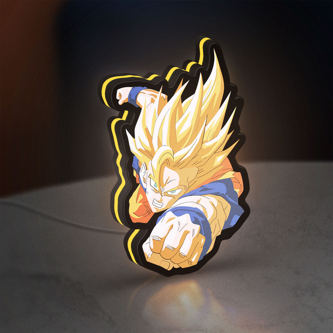 Goku LED lightbox hanging on a wall with yellow glow