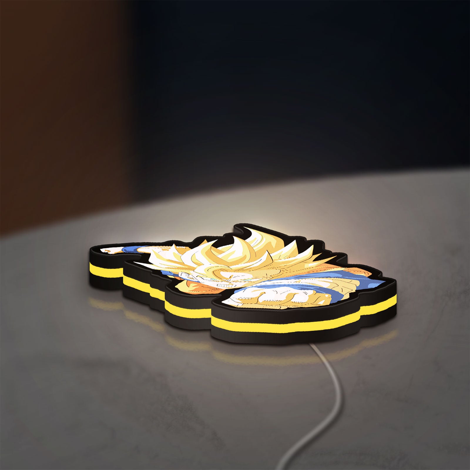 Goku LED lightbox lying flat on a desk with yellow glow
