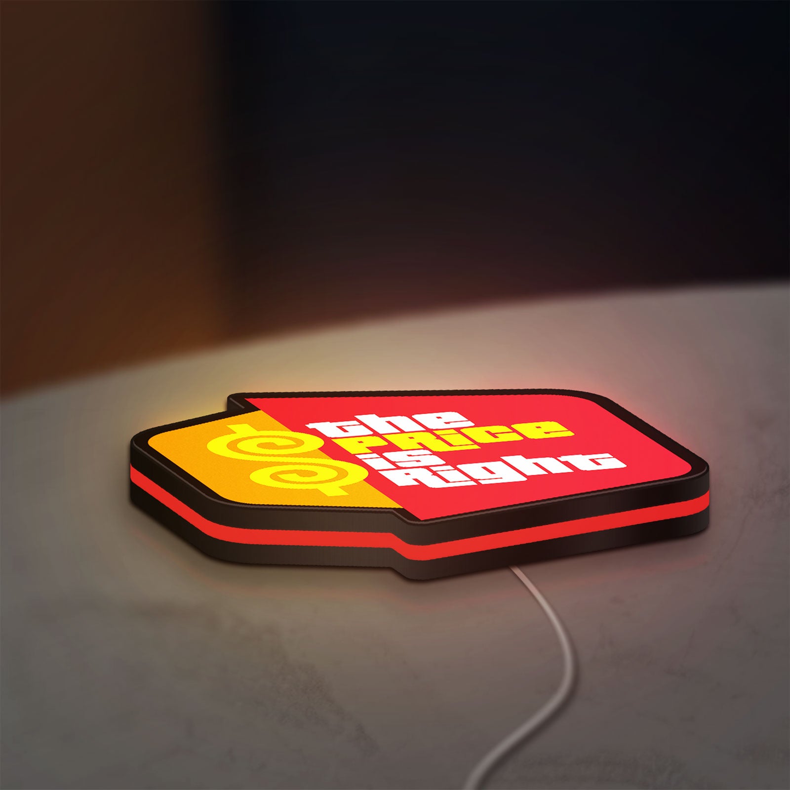 The Price is Right LED lightbox lying flat on a desk with red glow
