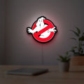 Ghostbusters LED lightbox hanging on a room wall with soft red light