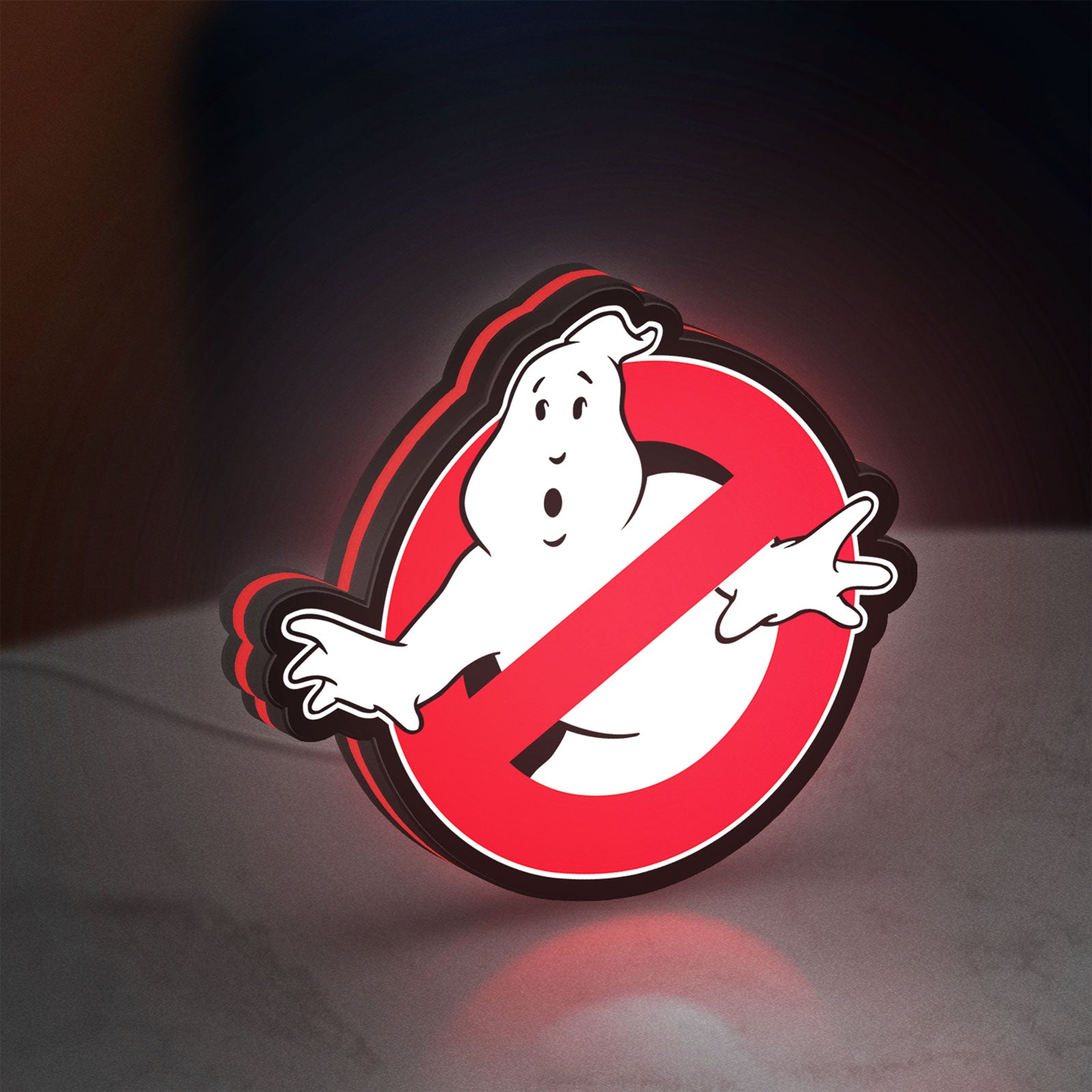 Ghostbusters LED lightbox standing on a desk from an angled side view with red glow