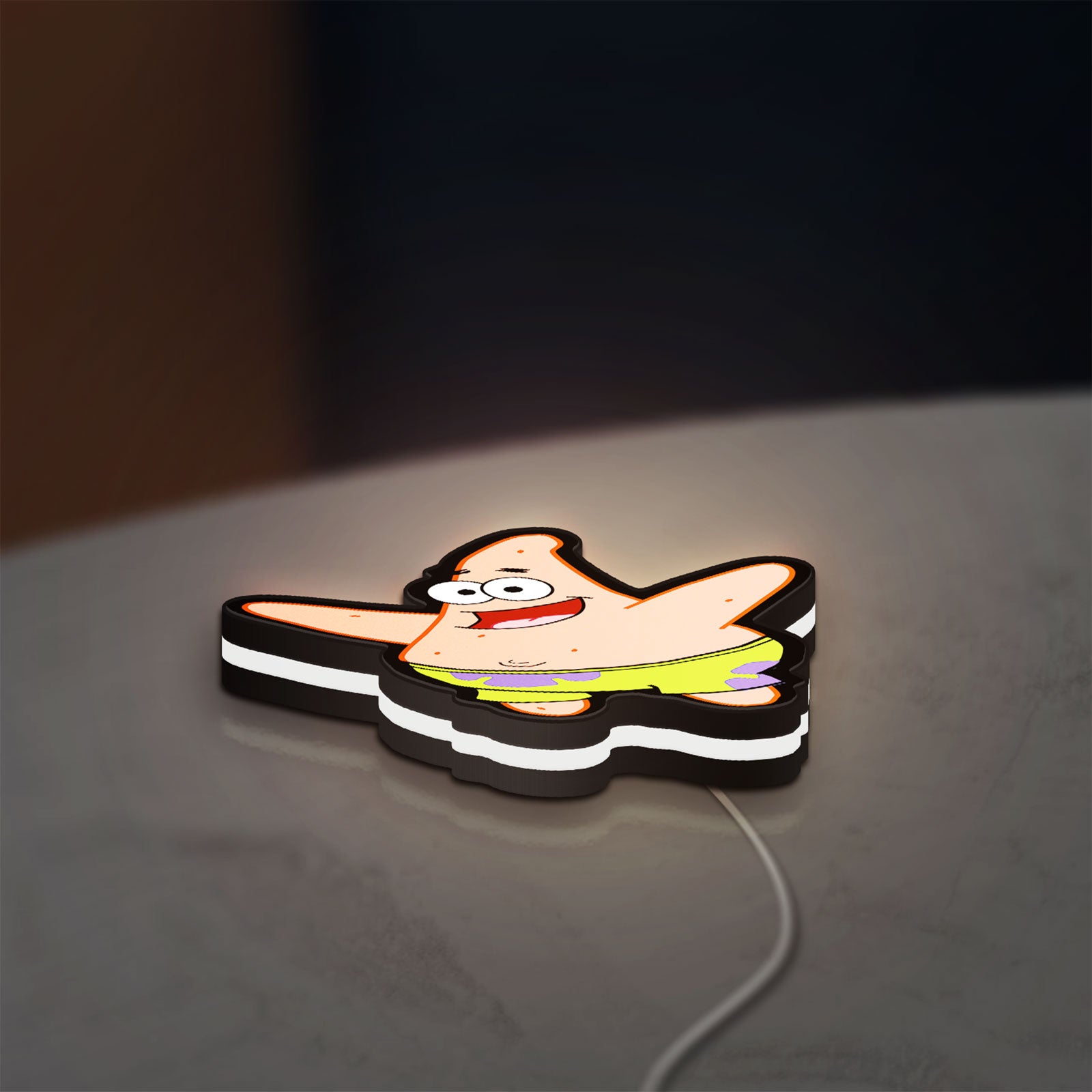 Patrick Star LED lightbox lying flat on a desk with white glow